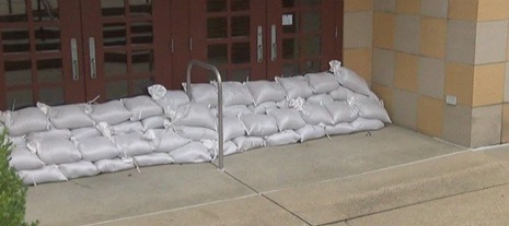 sandbags piled against school doors